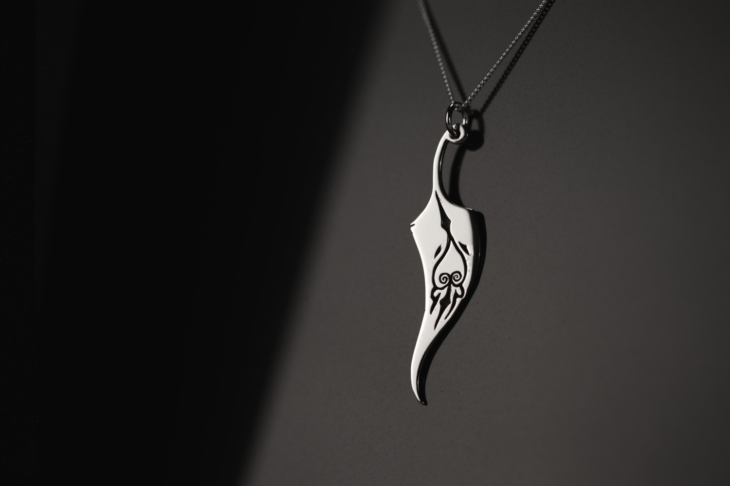 Magical Feather necklace in the shape of a feather.